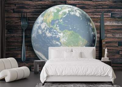 The planet Earth plate with a fork and knife on a wooden background. World hunger concept. Feed the world. Wall mural