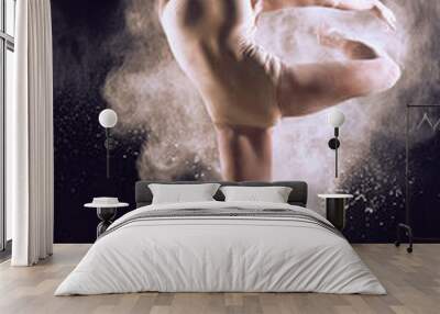 Dancer performing over black background with powder burst to show power and movement. Dancer performing over black background with powder. Wall mural