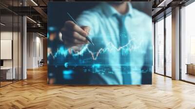 A businessman is drawing an upward-trending graph with an arrow on a virtual screen, symbolizing stock market growth or the positive impact on business trends. Wall mural