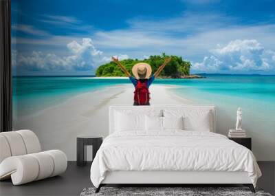 A vibrant beach scene depicting a lone traveler standing on a pristine white sand path that leads to a lush green island in the background. Dressed in a colorful skirt, a red backpack, and a wide-brim Wall mural