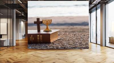 Gold Menorah & Christian cross & bible against  beach and  blue sea Wall mural