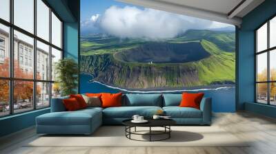 Aerial view of a lush green volcanic crater by the ocean under a bright sky. Wall mural