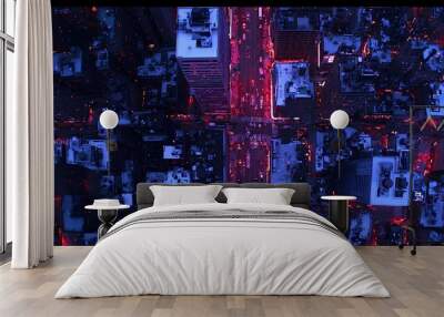 Aerial view of a vibrant urban nightlife, showcasing busy streets and glowing buildings. Wall mural