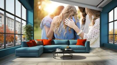 Closeup shot of female with their arms on each other while praying with a blurred background Wall mural