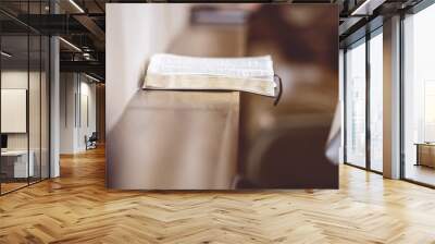 Open Bible on a wooden surface in the church Wall mural