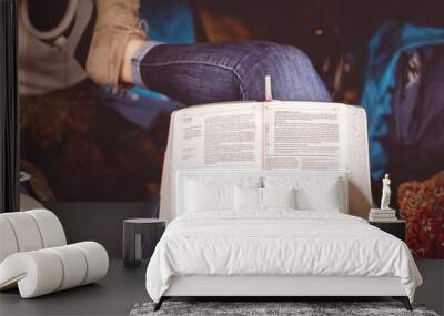 Overhead shot of a female reading the Bible during a church gathering Wall mural