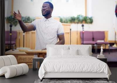 Shallow focus shot of a male reading the bible in the church Wall mural