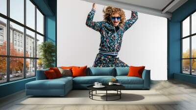 Excited adult funny man in stylish vintage clothes posing on white studio background. 80s fashion. Funky guy in tracksuit and sunglasses expressive indoor unusual portrait. Shouting cheerful male. Wall mural