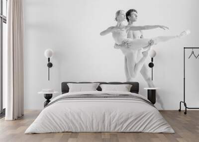 Young couple of modern ballet dancers posing over white studio background Wall mural