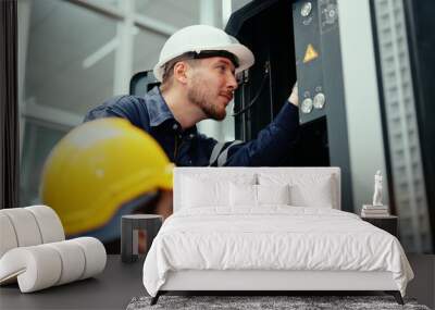 Two Caucasian production engineers in safety wear are assisting in adjusting and maintaining CNC machine in the factory. Male factory workers are examining the industrial machine to find an error. Wall mural