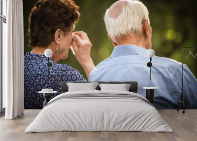 Elderly couple crying and watching sad or happy situation together. Wall mural