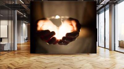 Hand holding light bulb Wall mural