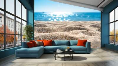 Sunny tropical beach with sand, sea, and blue sky, featuring waves, rocks, and a clear Wall mural