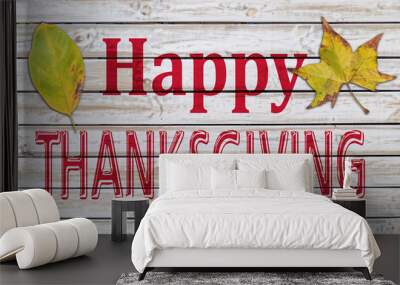 Happy Thanksgiving written on white wooden table with two autumn leaf Wall mural