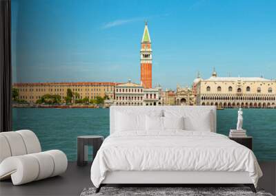 Panorama of San Marco bell tower in San Marco square in Venice with Saint Mark Basilica of Venetian city, Italy. sea view from Giudecca canal by cruise boat trip in Venetian lagoon by ferry boat. Wall mural