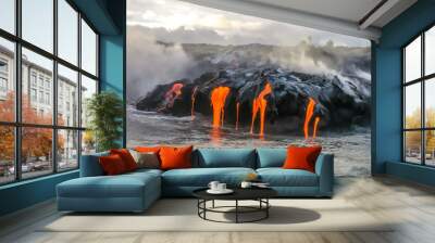 Sea view of Kilauea Volcano in Big Island, Hawaii, United States. A restless volcano that has been in business since 1983. Shot taken at sunset when the lava glows in the dark as jumps into the sea. Wall mural