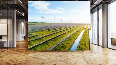 Wind turbines and solar panels farm in a field. Renewable green energy. Sunny landscape, electric energy generator for clean energy producing concept. Solar panels and wind power generation equipment Wall mural