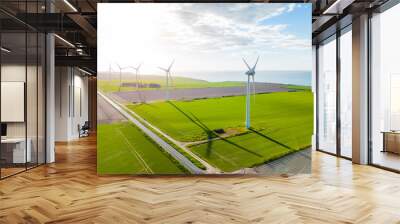 Wind turbines farm in sunlight. Clean energy concept, wind turbines in the sunlight on the coast close to the sea for wind power Wall mural