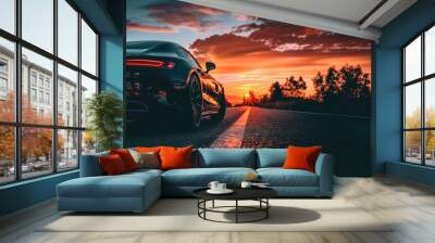 Black car on the road, red sun above the horison, clouds in the sky Wall mural