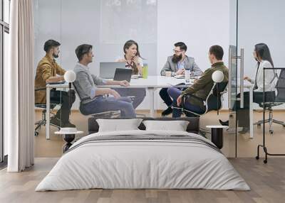 Corporate business team and manager in a meeting at IT company office conference room. View through glass wall. Wall mural