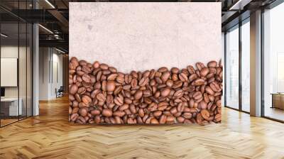 Coffee beans on a brown textured background, empty copy space Wall mural