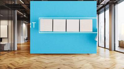 New start, achieving new goals, loading bar with wooden cubes, blue colored background, business concept Wall mural