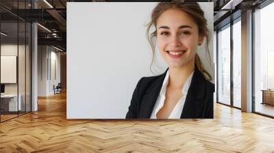 Perfect business lady. Beautiful young businesswoman looking at camera with smile while standing against white background.  Wall mural