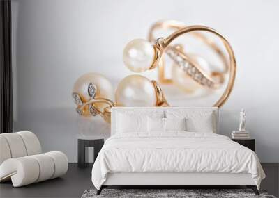 Elegant gold rings and gold earrings with pearls Wall mural