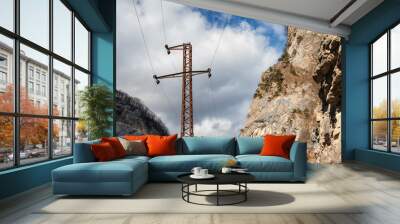 The poles of the power line laid in a mountainous area at high altitude Wall mural