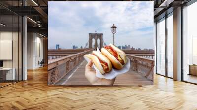 Holding two hot dogs in NYC on the Brooklyn Bridge Wall mural