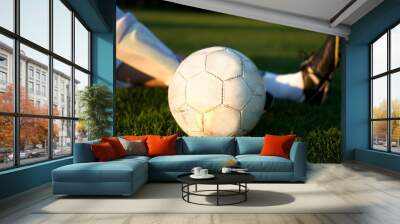 legs of a soccer player with ball in sunset on soccer field Wall mural