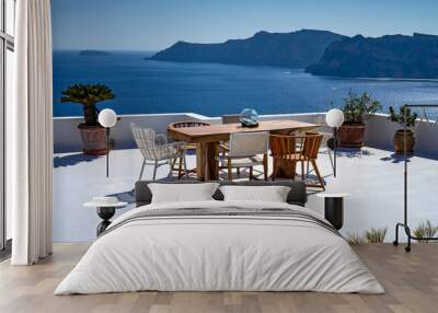 Romantic mediterraen vacation lunch on a rooftop over the sea in Santorini Wall mural