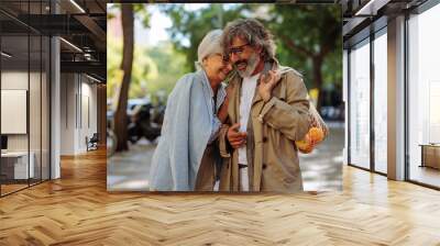 Affectionate mature couple outside. Wall mural