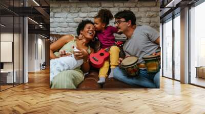 Bonding time of adorable multiracial family at home Wall mural