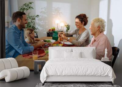 Happy family is having lunch in the dining room Wall mural