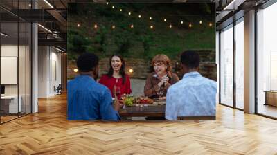 Laughter at an outdoor dinner party Wall mural