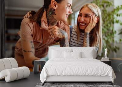 Lesbian women working together at home Wall mural