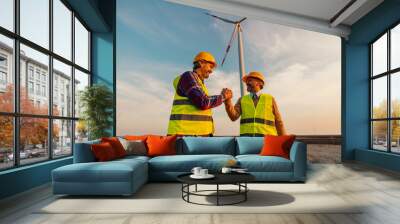 Two engineers standing in field with wind turbines Wall mural