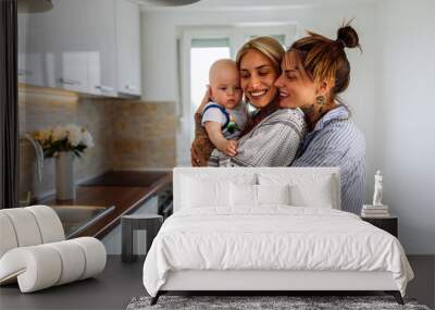 Two lesbian women with a baby boy at home Wall mural