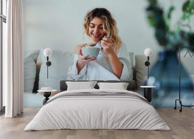 Woman having breakfast at home Wall mural