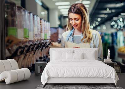 woman working at a grocery store and using tablet Wall mural