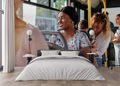 Young black woman in public transport Wall mural