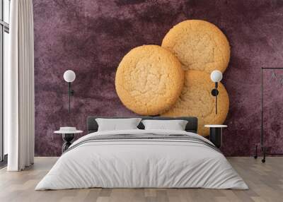 Top view of three soft sugar cookies on a red background Wall mural