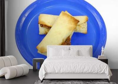 Two baked burritos on blue plate Wall mural