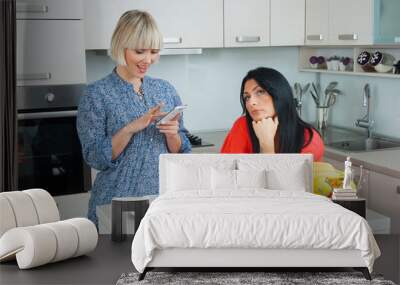 woman texting on mobile phone in company Wall mural