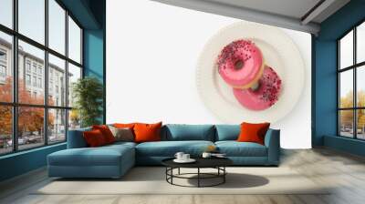 Donuts with pink cream in a white plate on a white background Wall mural