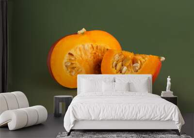 Pumpkin and pumpkin slices on a green background Wall mural