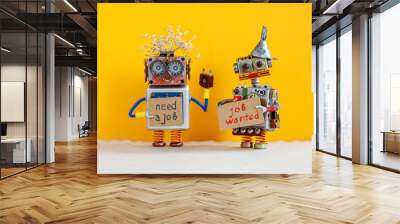 Job search concept. Two robots wants to get a job. Smiley unemployed robotic characters with a cardboard sign and handwritten text Need a job and Job Wanted. Yellow background Wall mural