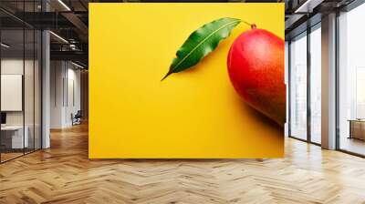 Minimal concept of a red mango with leaf on yellow background Wall mural