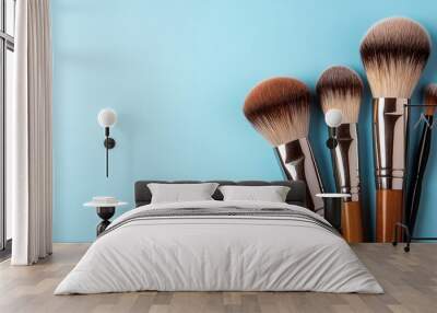 Soft natural brushes for makeup application on blue background with copy space Wall mural